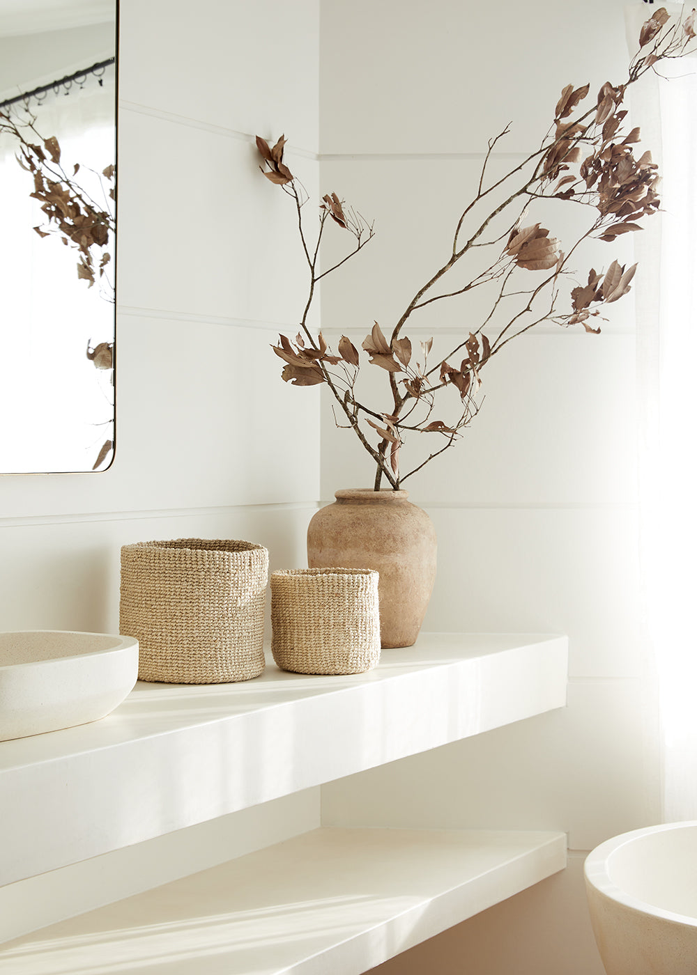 Jute storage baskets used in a bathroom vanity.