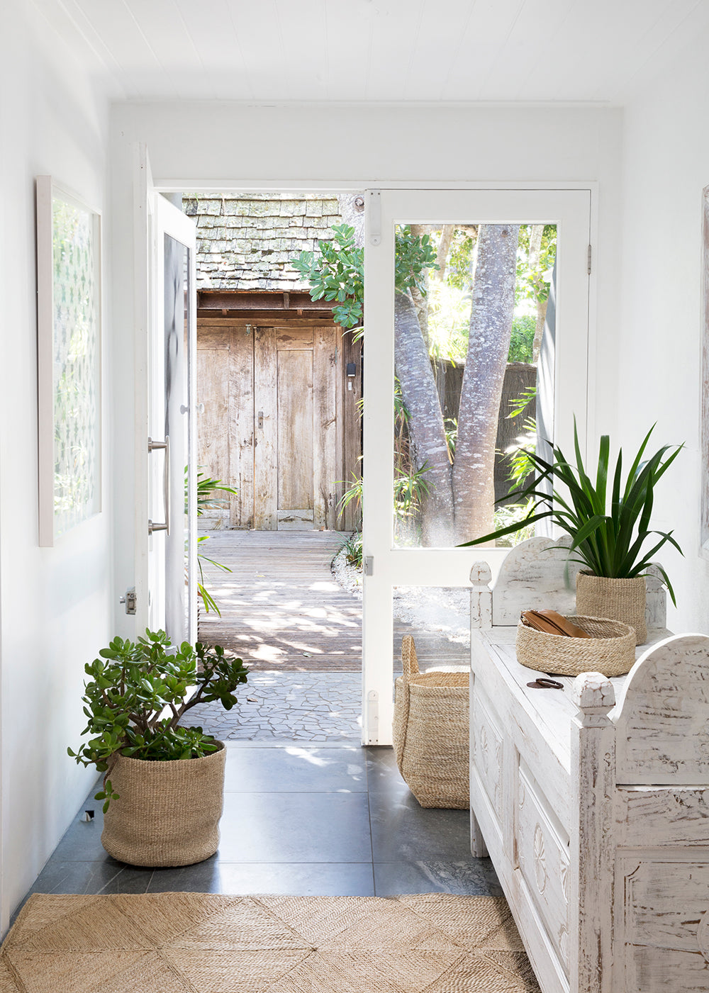 Welcoming entryway with Dharma Door jute rug and handwoven jute baskets for organisation