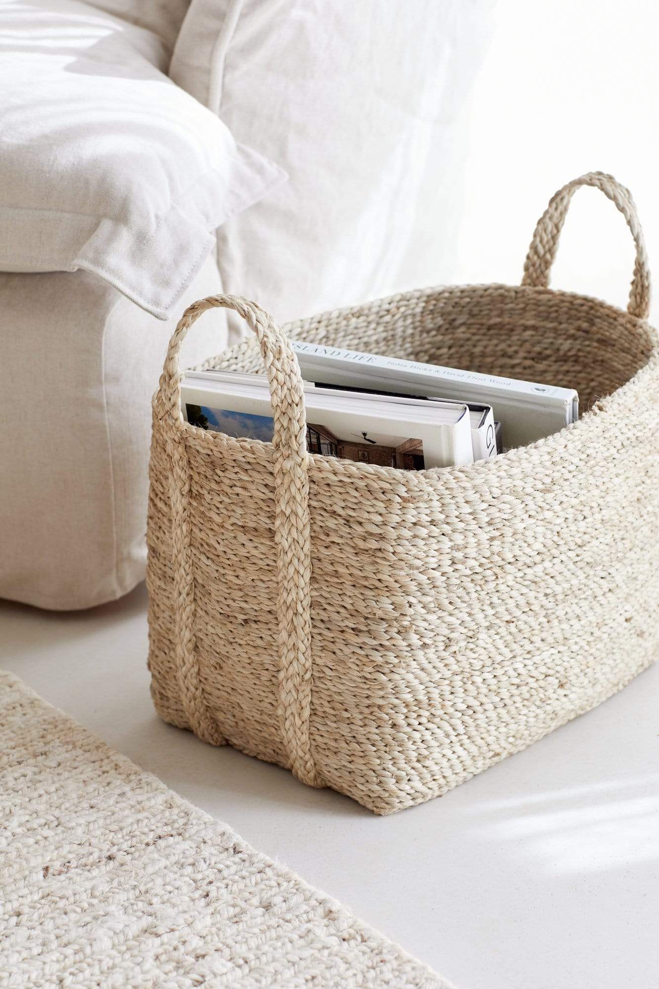 Small to medium natural jute basket holding books 